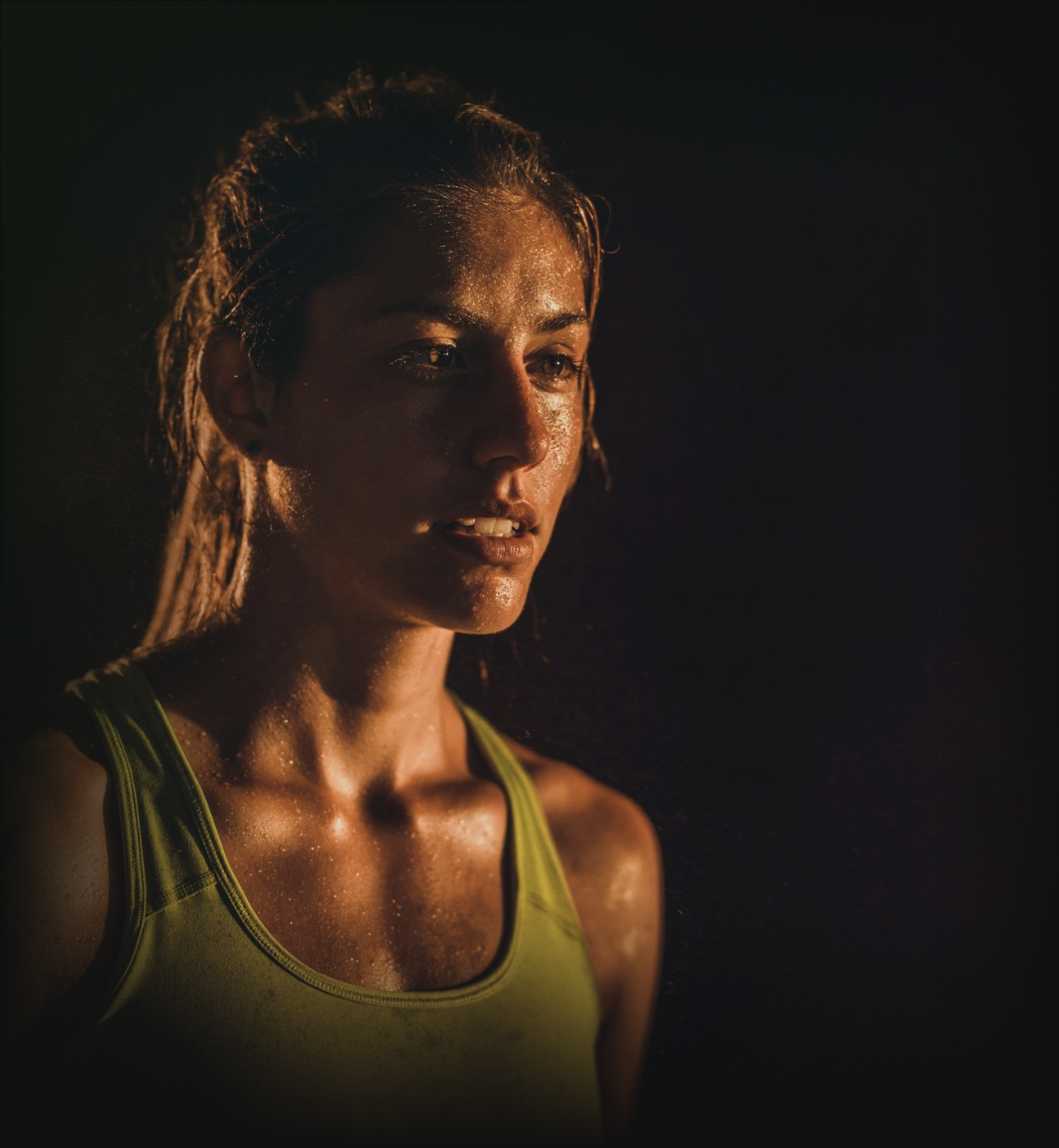 Focused endurance athlete in low-key studio light